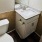 half bathroom with toilet sink and mirror at Cary Pines Apartments in Cary, NC