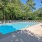 Pool with a sundeck at Cary Pines Apartments in Cary, NC