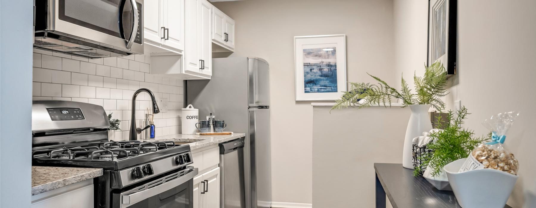a kitchen with white cabinets