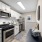 galley style kitchen with ample lighting at Cary Pines Apartments in Cary, NC