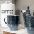 coffee mugs, and accoutrements on kitchen counter